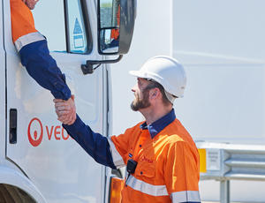 Two truck drivers shaking hands 
