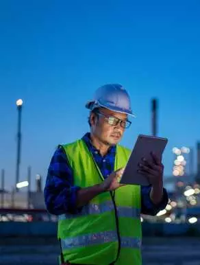 Man standing reading a tablet