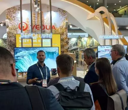 Visitors at a Veolia stand at an exhibition